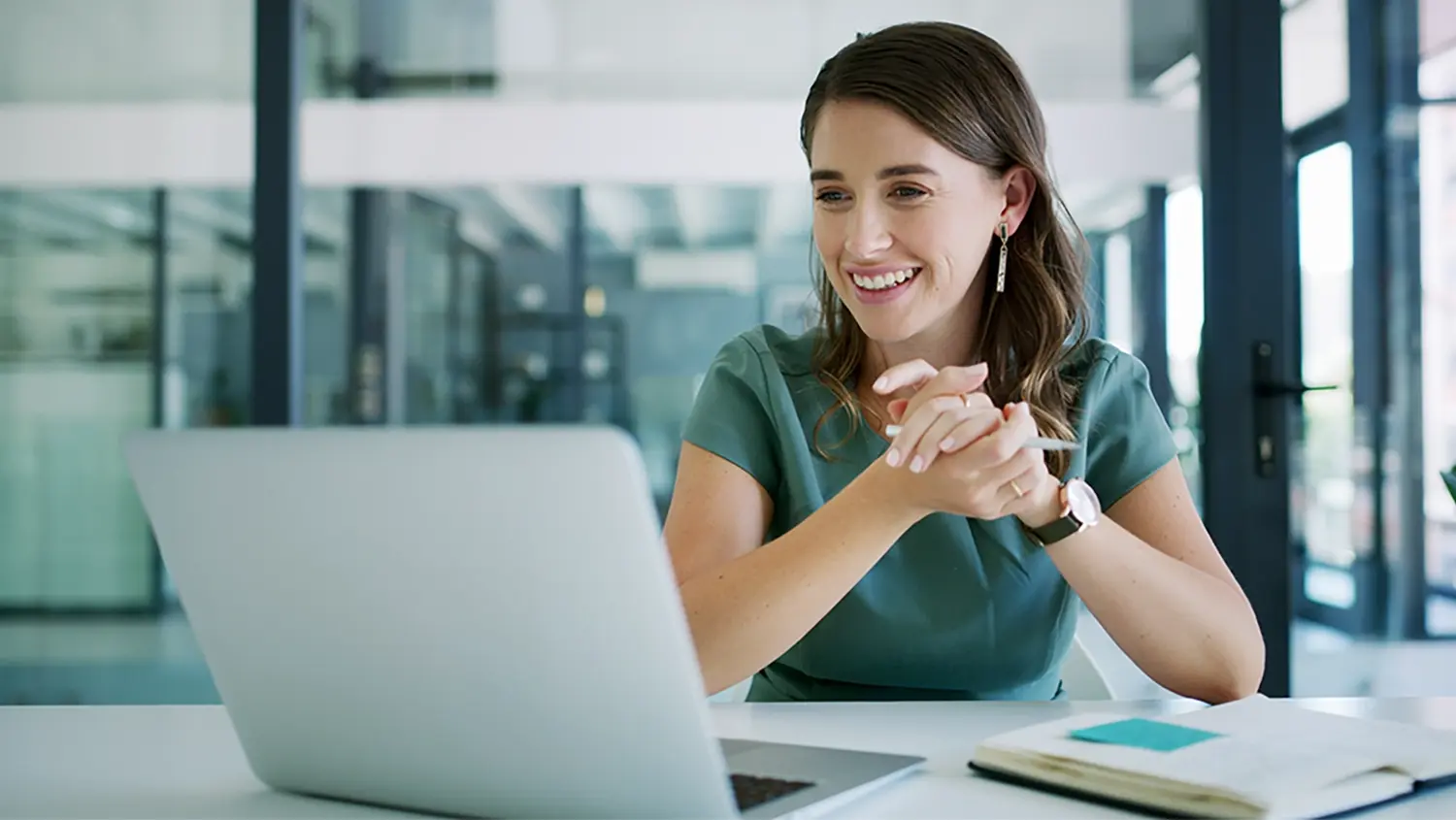 Woman smiling in front of computer