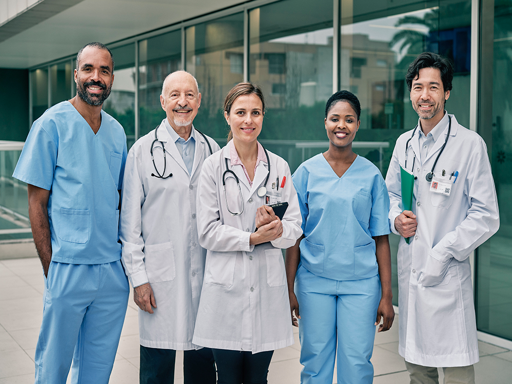 A group of healthcare workers standing in front of a building